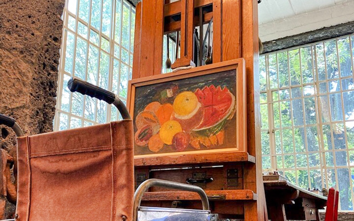 Wheelchair and easel with fruit painting at Frida Kahlo Museum, Mexico City.
