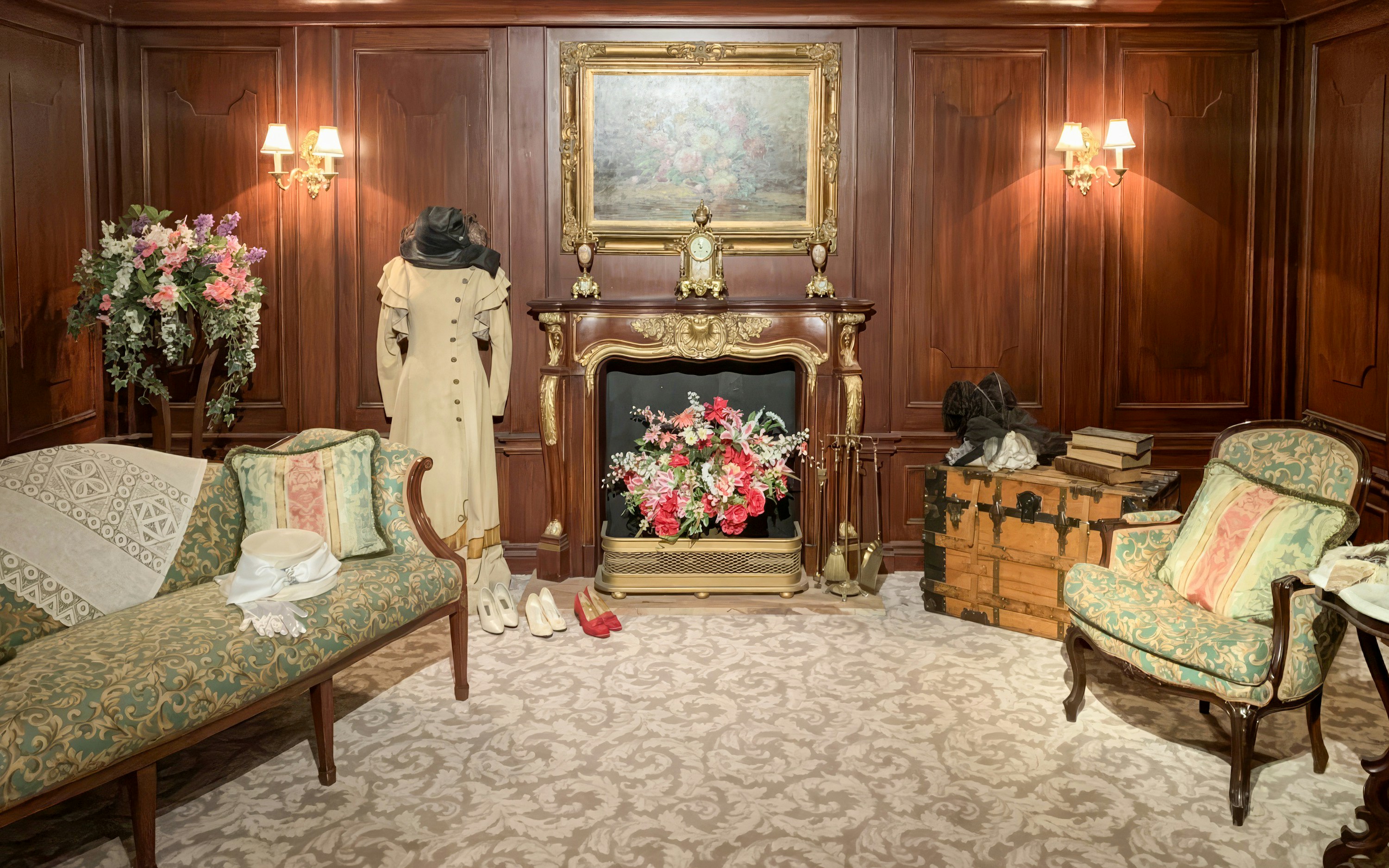 Titanic first-class cabin replica with period furniture and clothing display.
