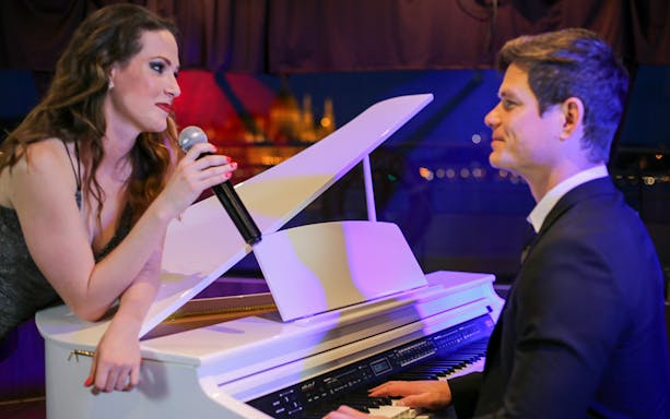 Pianist and singer performing on Budapest dinner cruise.