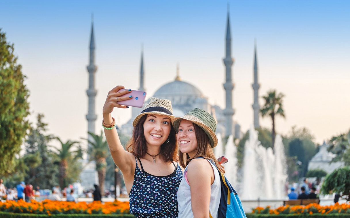 Tourists taking a selfie in front of the Blue Mosque, Istanbul.