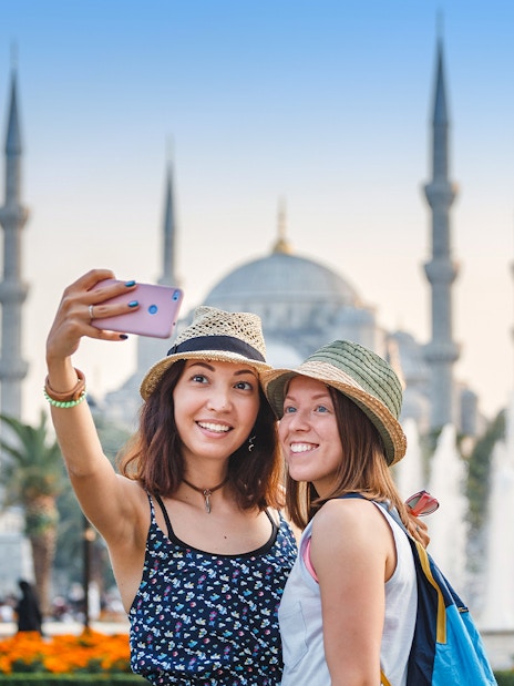 Tourists taking a selfie in front of the Blue Mosque, Istanbul.