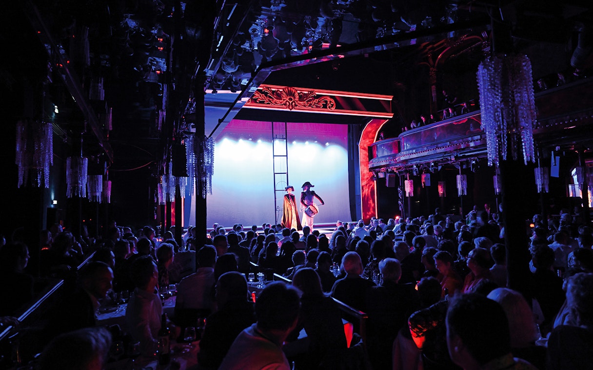 Audience watching a festive show at Paradis Latin in Paris.