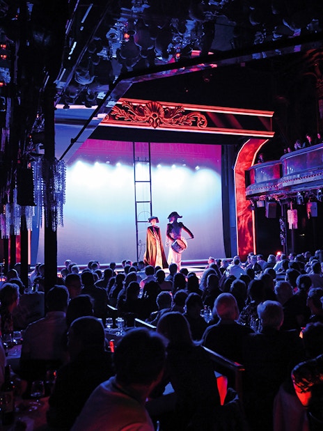 Audience watching a festive show at Paradis Latin in Paris.