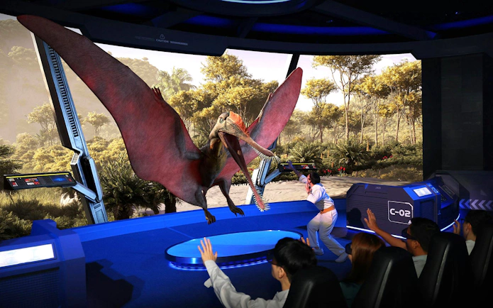 Interactive dinosaur exhibit with a pterosaur display, engaging visitors in a futuristic setting.