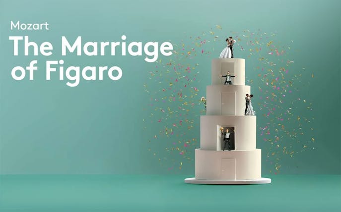 Mozart's The Marriage of Figaro characters on a tiered cake with confetti.