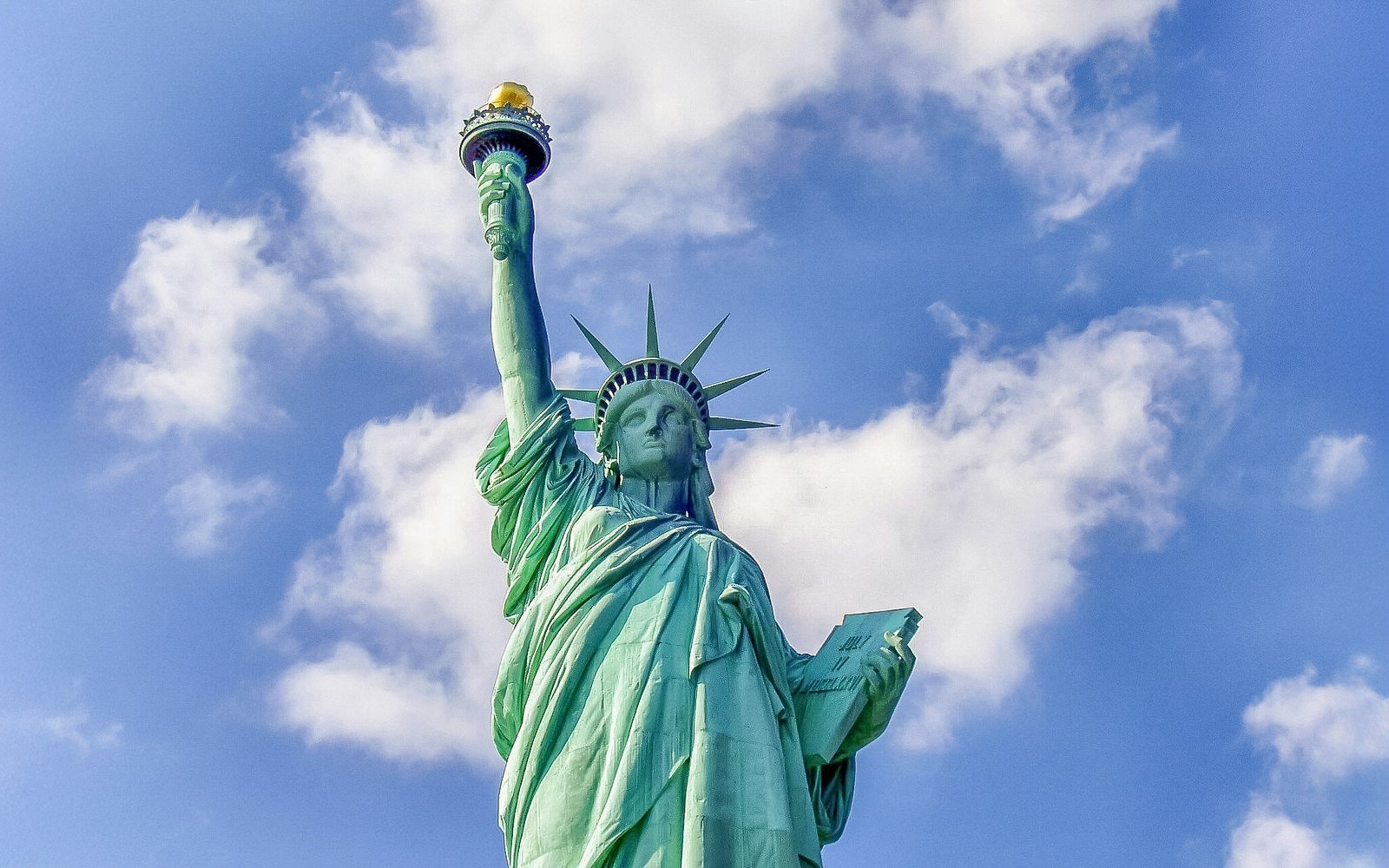 Statue of Liberty with New York City skyline in the background.