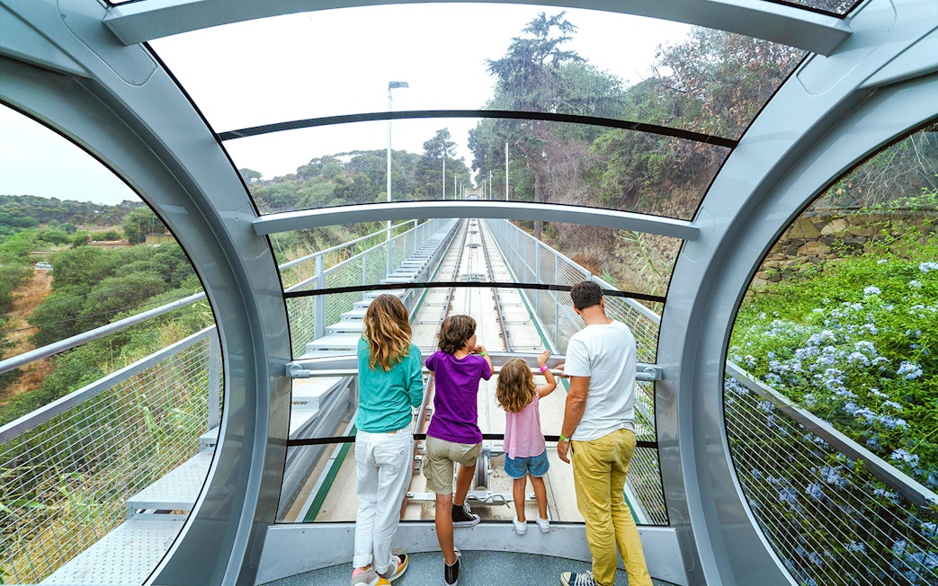 Interior view of funicular at Tibidabo Amusement Park with passengers looking out.
