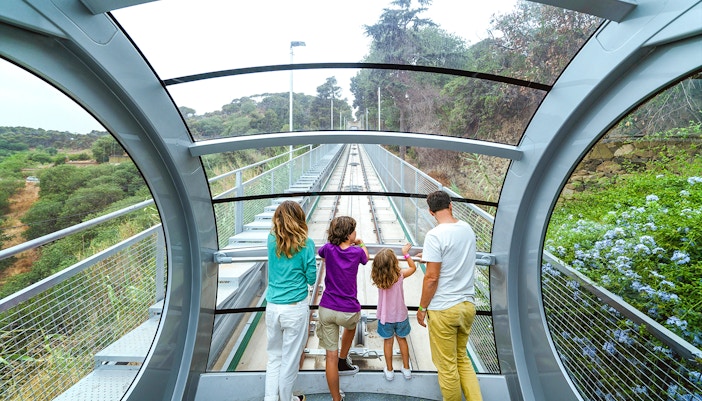 Interior view of funicular at Tibidabo Amusement Park with passengers looking out.