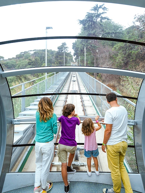 Interior view of funicular at Tibidabo Amusement Park with passengers looking out.