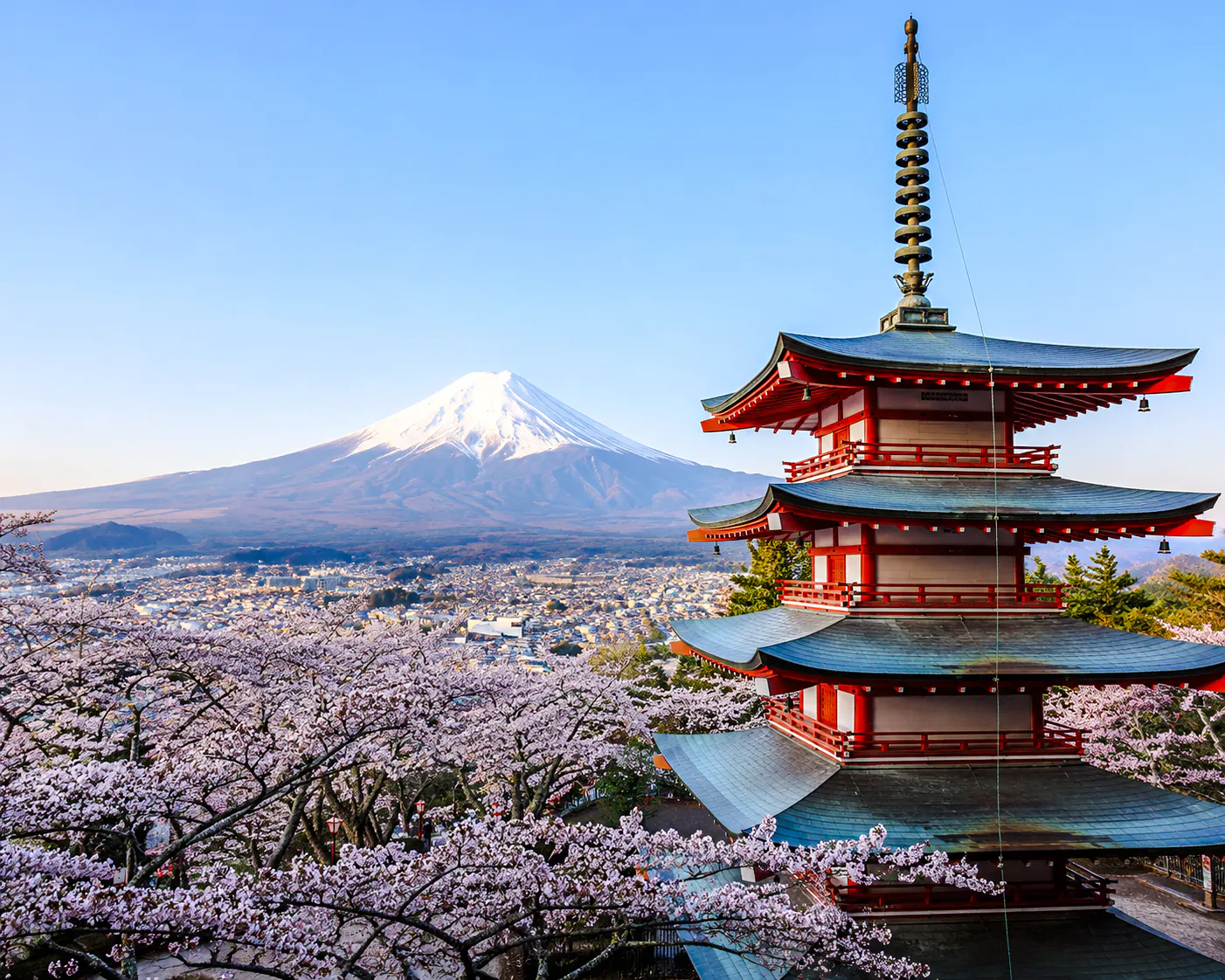 Pagoda with cherry blossoms and Mt. Fuji in the background, Fujiyoshida, Japan.