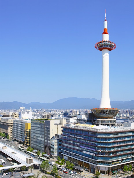 Kyoto Tower overlooking cityscape in Kyoto, Japan.