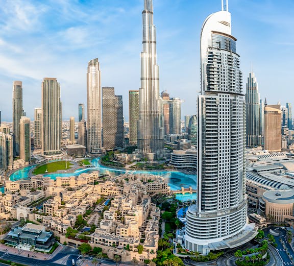 Panoramic view of Dubai's Business Bay skyline featuring the Burj Khalifa.
