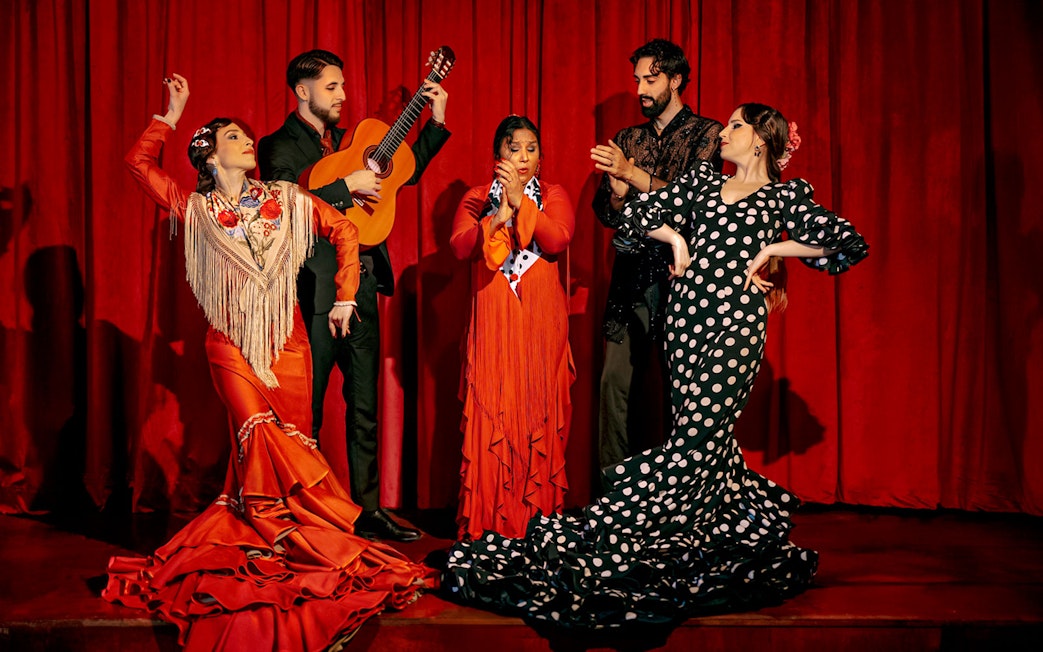 Flamenco dancers and guitarist performing on stage at Laietana, Barcelona.