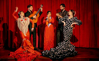 Flamenco dancers and guitarist performing on stage at Laietana, Barcelona.