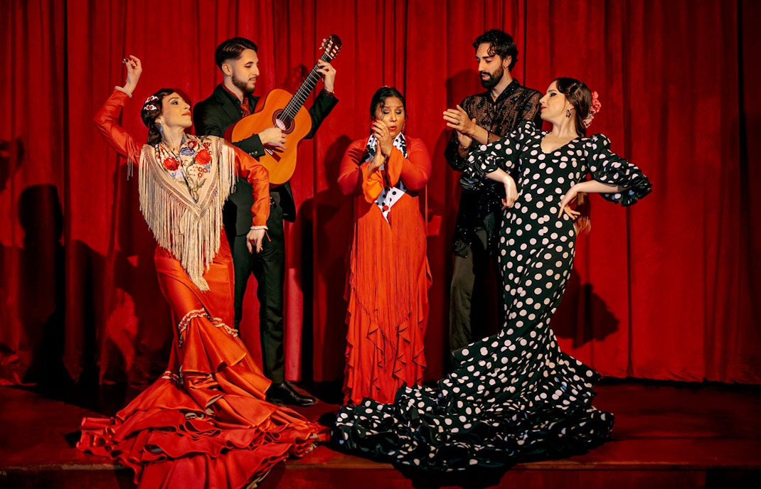 Flamenco dancers and guitarist performing on stage at Laietana, Barcelona.