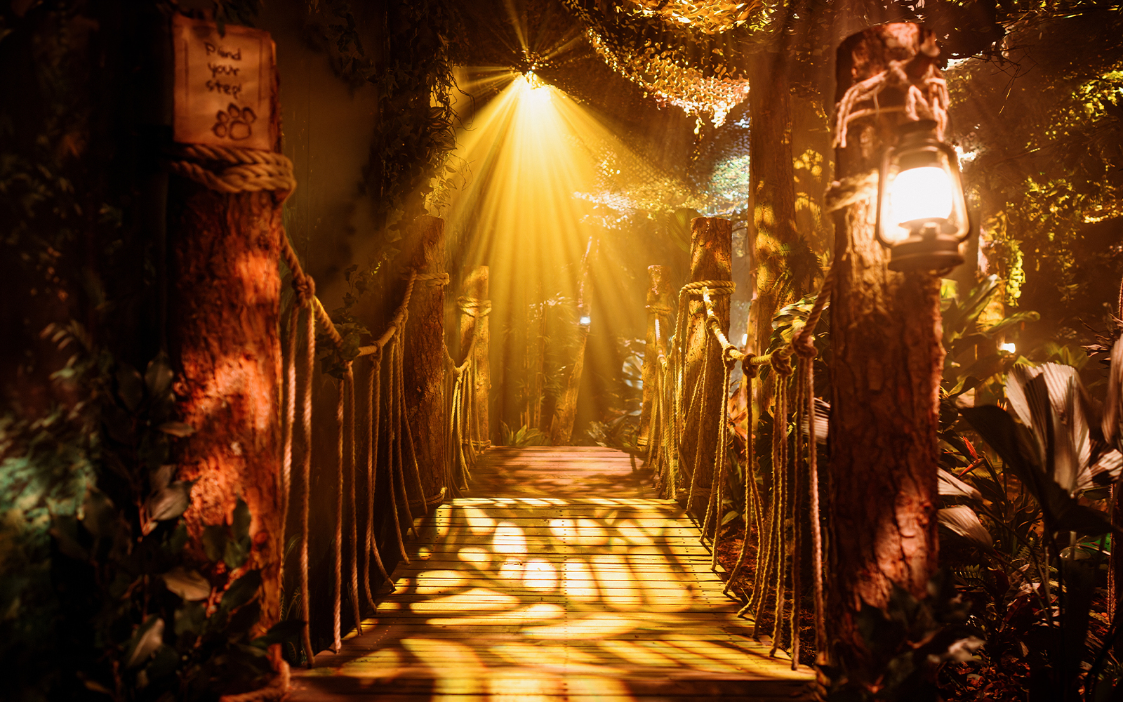 Rope bridge with lanterns and foliage at Peru setup, Paddington Experience.