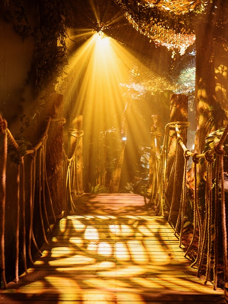 Rope bridge with lanterns and foliage at Peru setup, Paddington Experience.