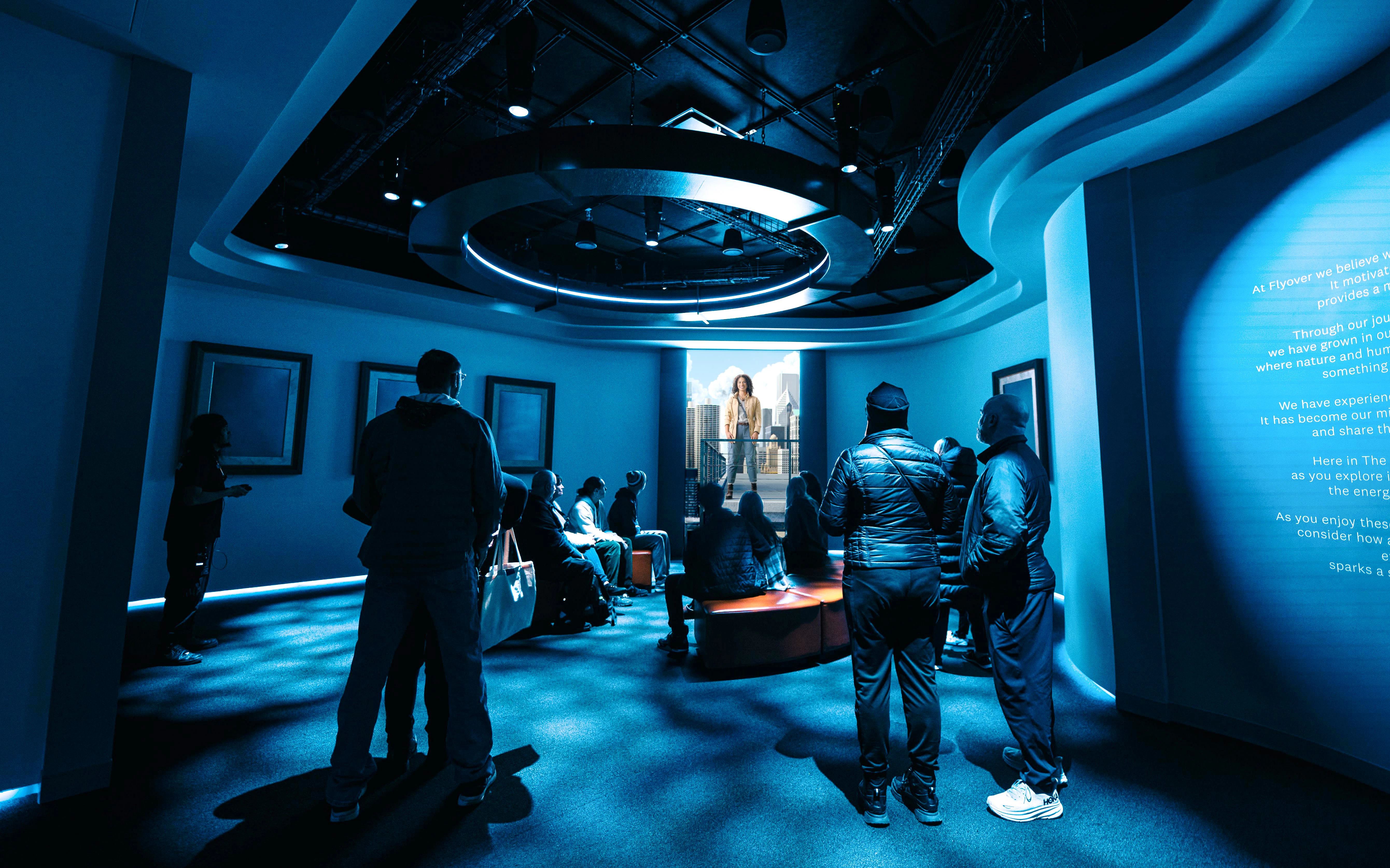 Visitors watching a presentation at the Flyover Chicago experience.