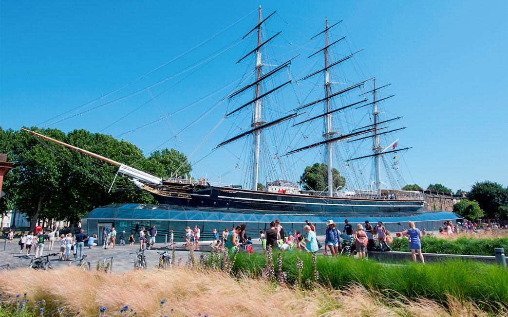 Cutty Sark ship at National Maritime Museum, London, with visitors nearby.