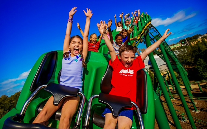 Children enjoying a roller coaster ride at an Orlando theme park.