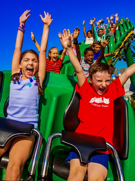 Children enjoying a roller coaster ride at an Orlando theme park.
