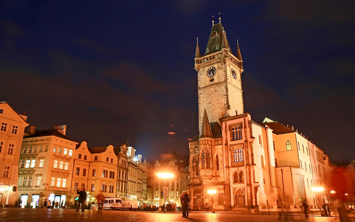 Medieval streets of Prague with Old Town Hall at night during Ghosts and Legends tour.