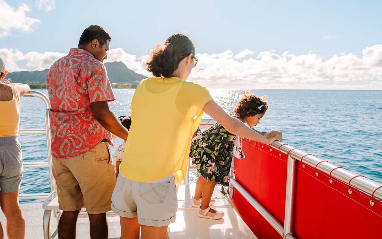 Guests enjoying views on a Hawaii glass-bottom boat tour.