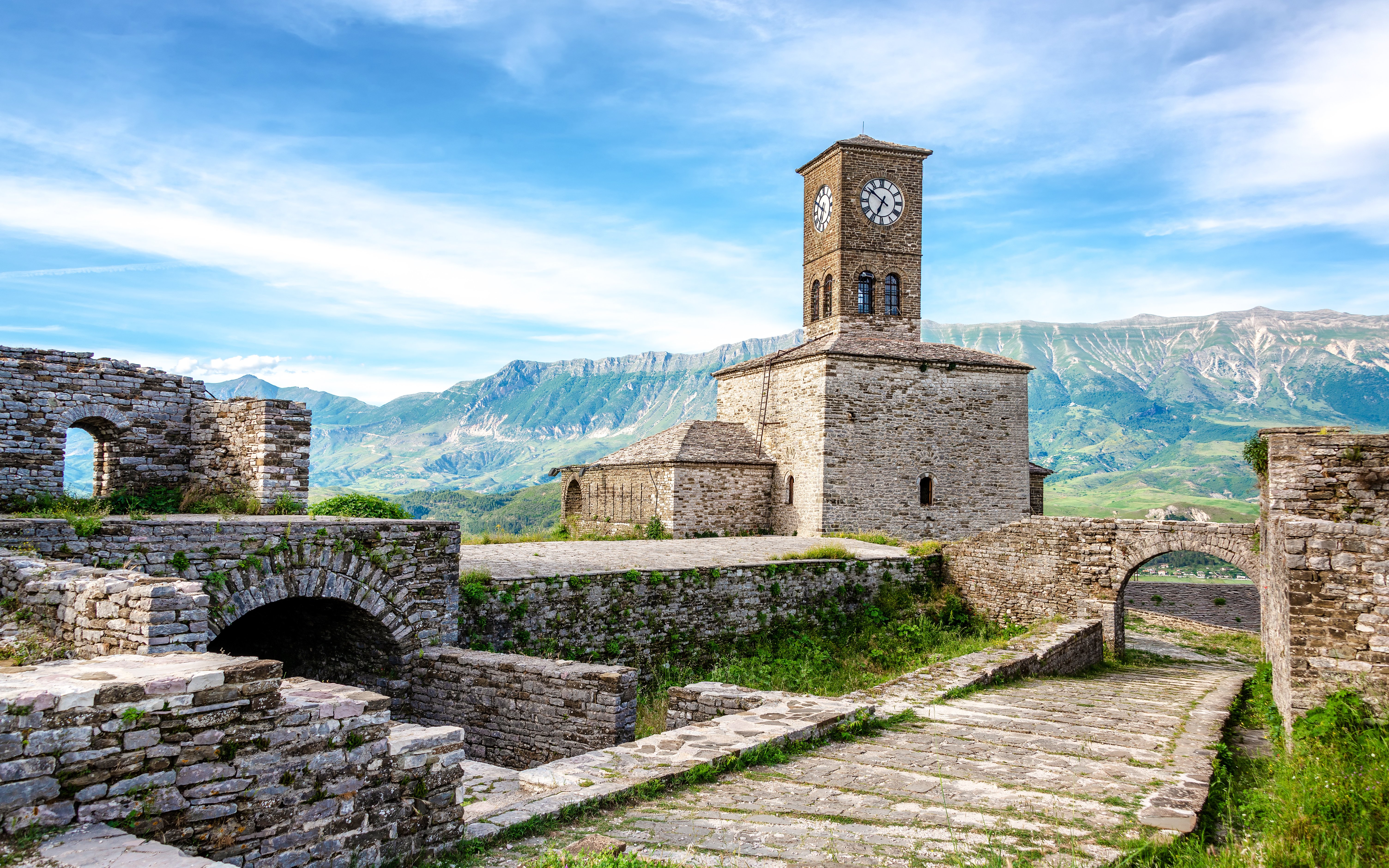 Clocktower at Gjirokaster Castle with mountain backdrop, Albania.