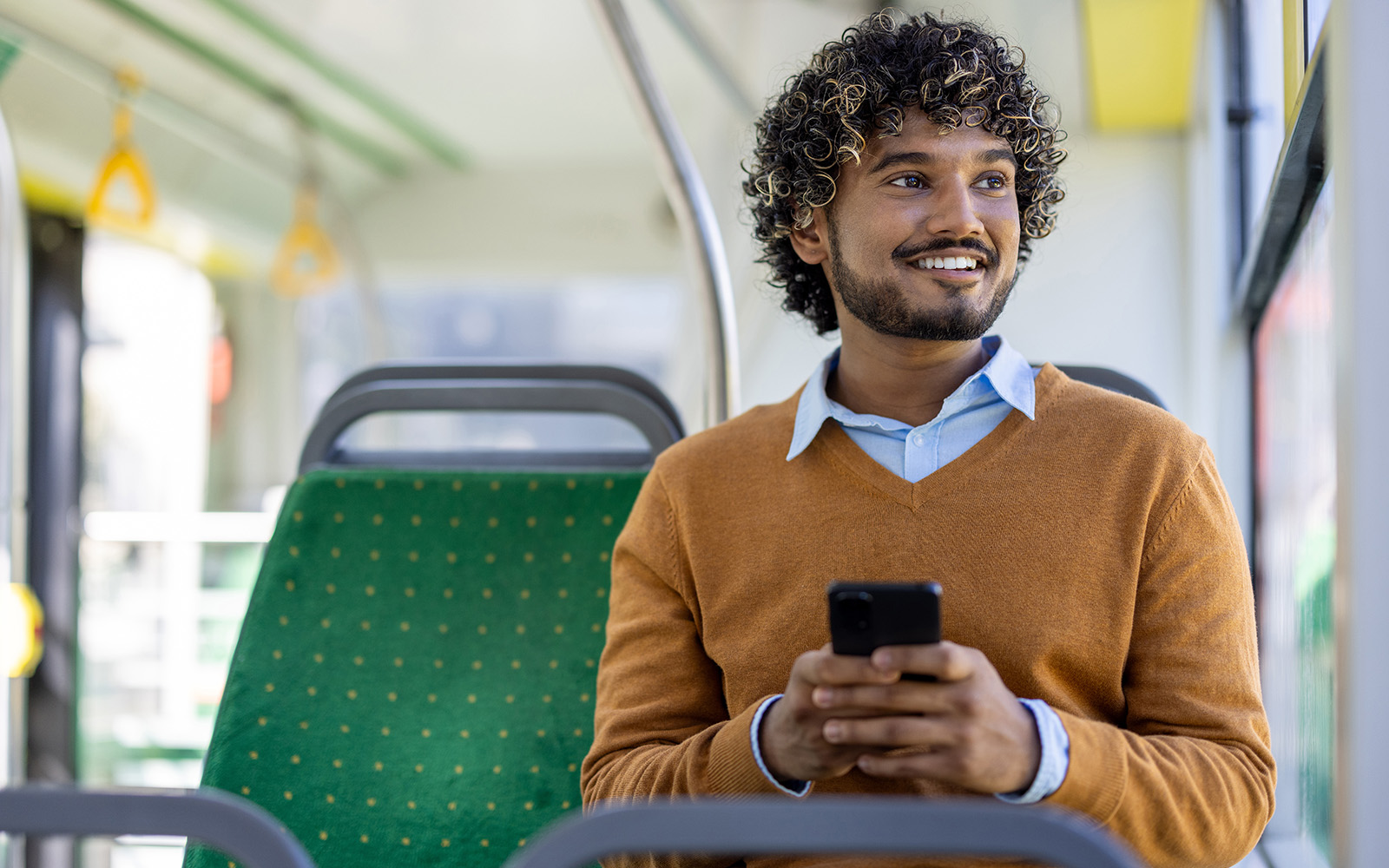 Solo traveler on a bus admiring the scenic view in Valencia through the window.