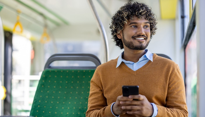 Solo traveler on a bus admiring the scenic view in Valencia through the window.