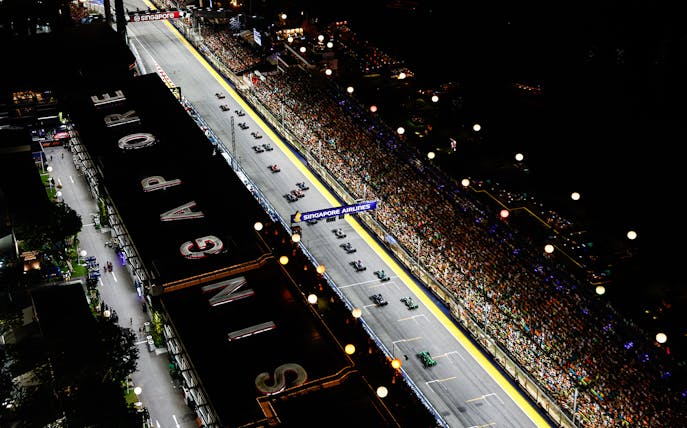 Aerial view of Formula 1 Singapore Grand Prix 2025 night race with packed grandstands.