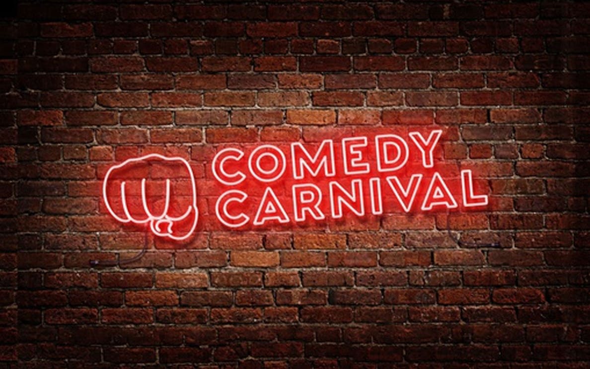 Comedy Carnival neon sign on brick wall, Covent Garden.
