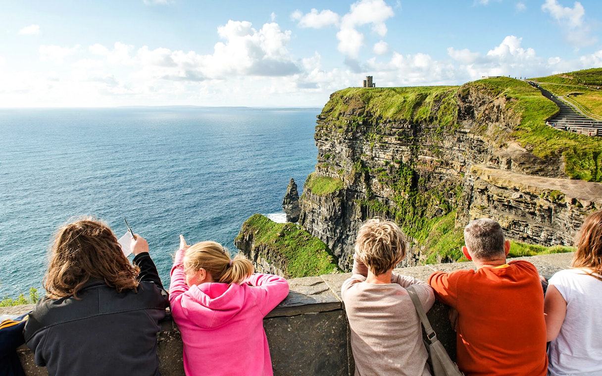 Tourists viewing the Cliffs of Moher in County Clare, Ireland.
