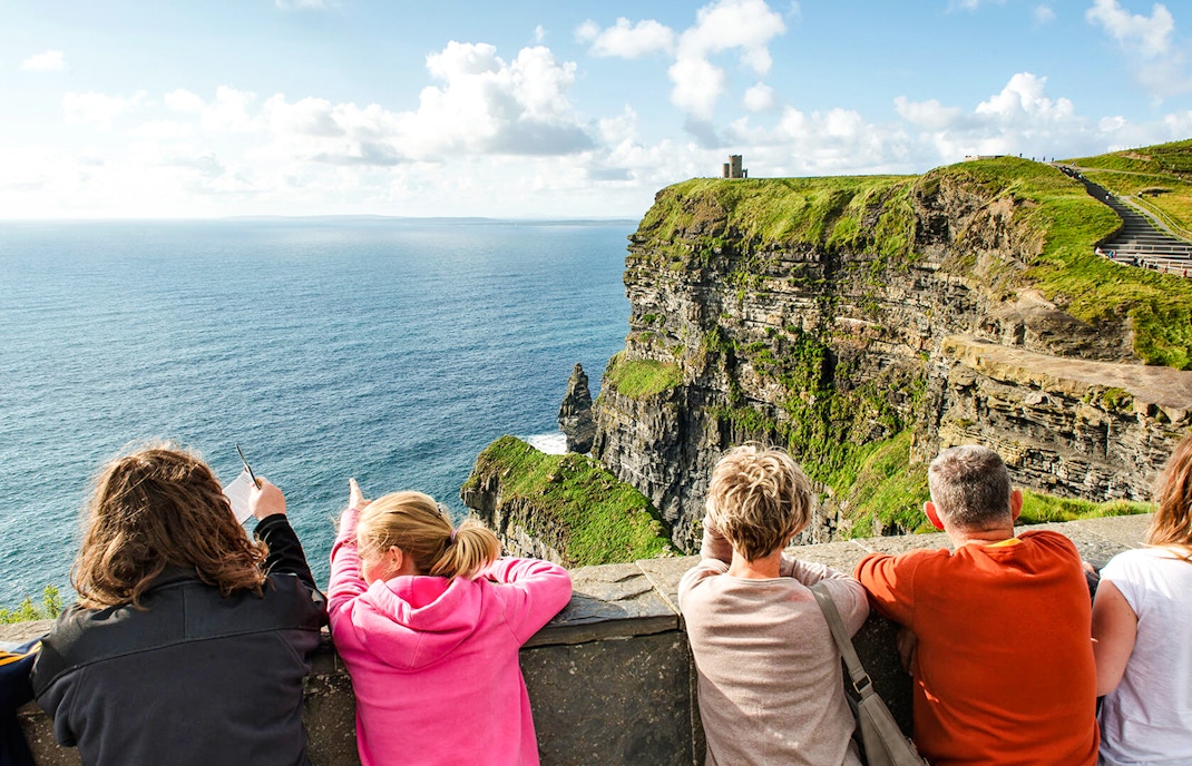 Tourists viewing the Cliffs of Moher in County Clare, Ireland.