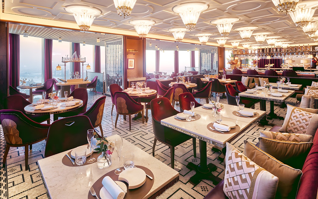 Dining area of At.Mosphere restaurant, Burj Khalifa, with elegant table settings and panoramic city views.