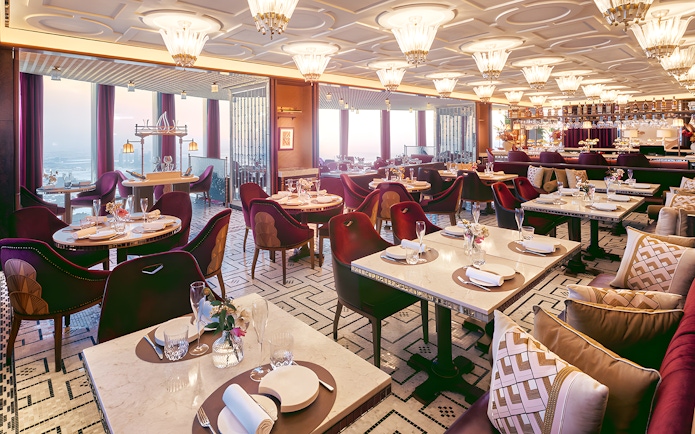 Dining area of At.Mosphere restaurant, Burj Khalifa, with elegant table settings and panoramic city views.