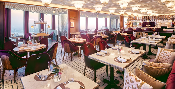 Dining area of At.Mosphere restaurant, Burj Khalifa, with elegant table settings and panoramic city views.