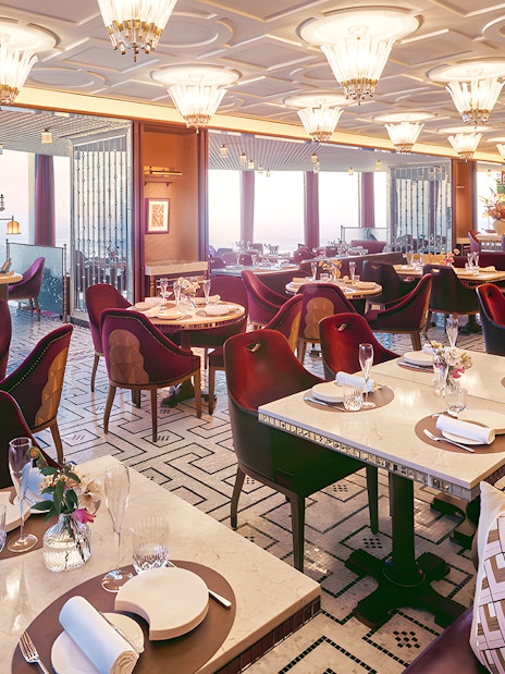 Dining area of At.Mosphere restaurant, Burj Khalifa, with elegant table settings and panoramic city views.