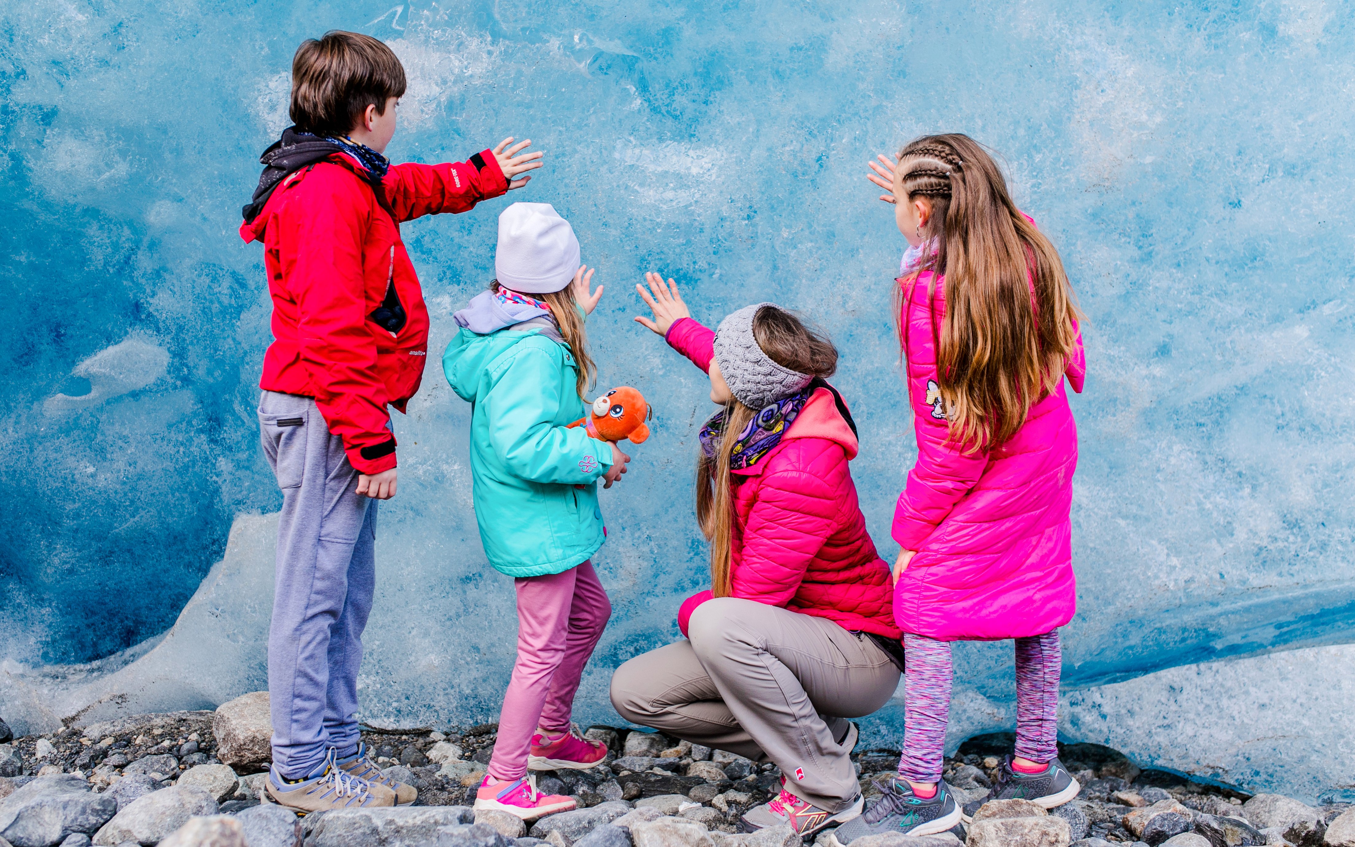 Guests touching Perito Moreno Glacier wall during guided tour in Azul, Argentina.
