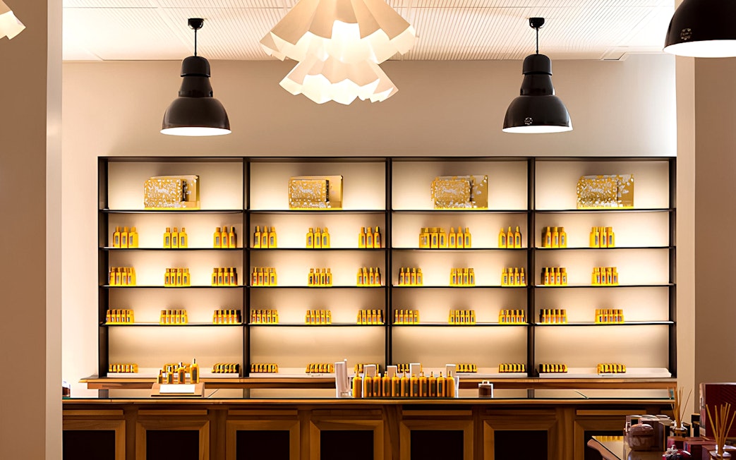 Fragonard Perfume Museum display shelves with various perfume bottles in Paris.