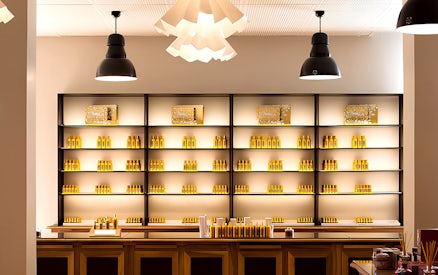 Fragonard Perfume Museum display shelves with various perfume bottles in Paris.
