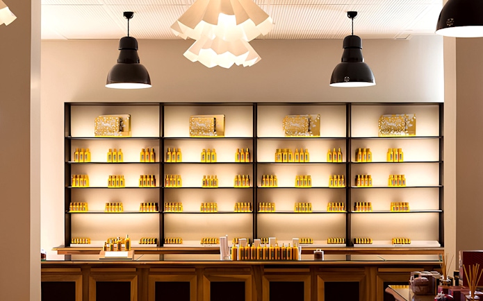 Fragonard Perfume Museum display shelves with various perfume bottles in Paris.