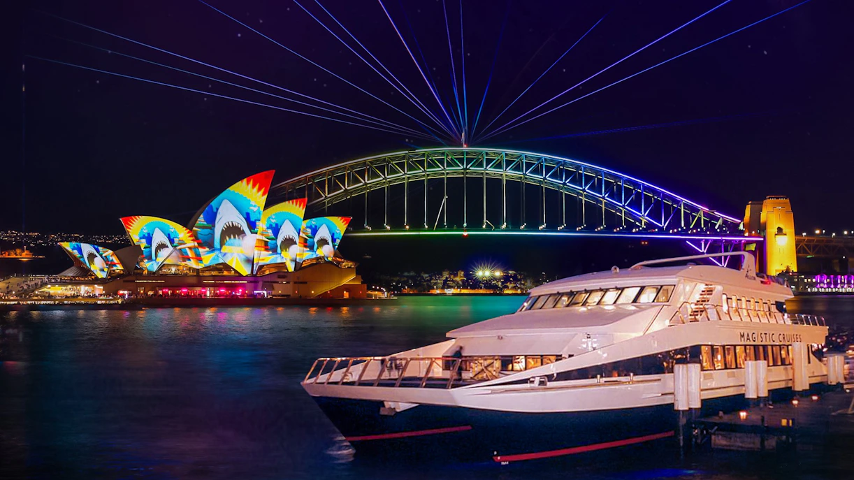 Sydney Opera House and Harbour Bridge illuminated during Vivid Sydney cruise.