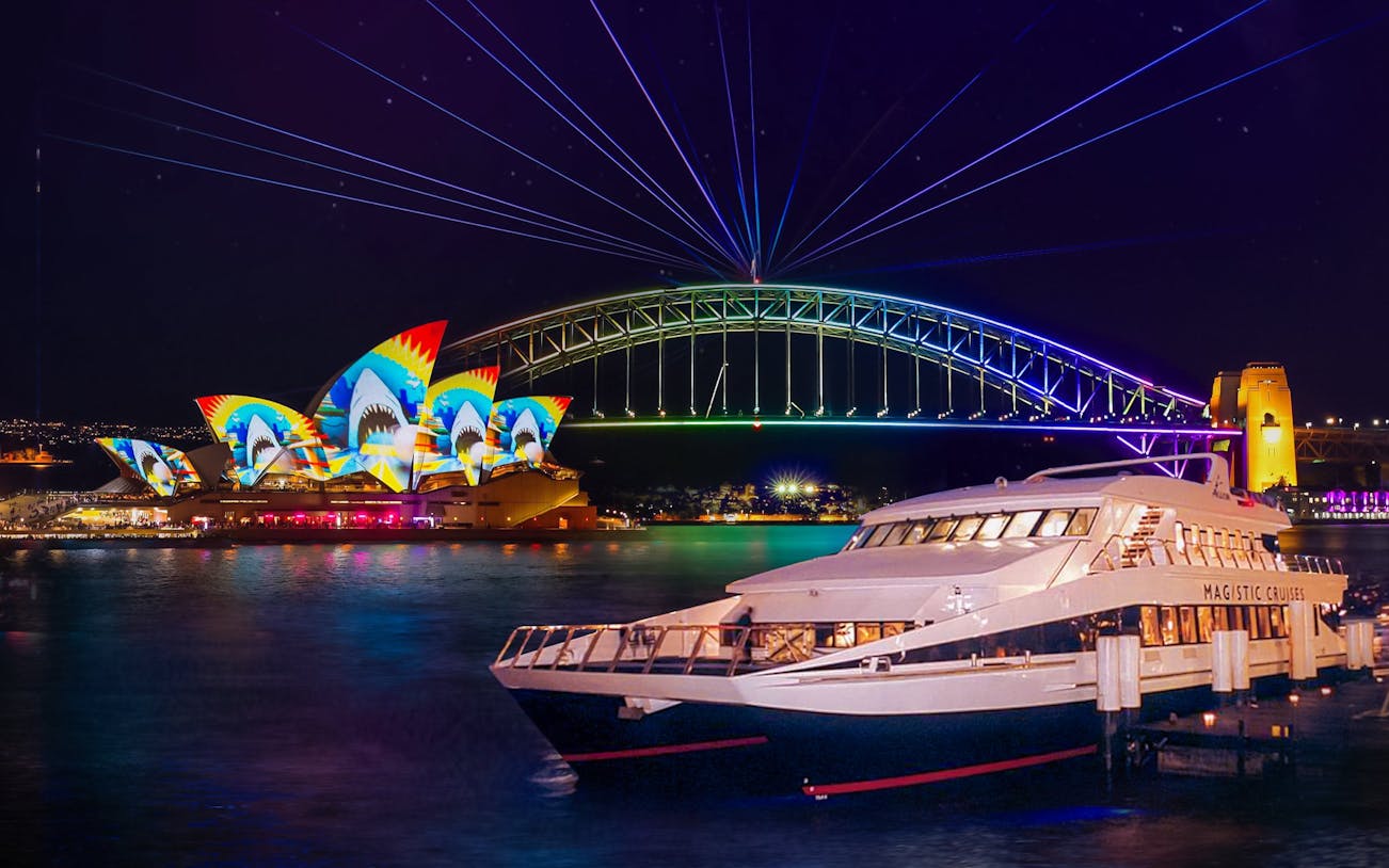 Sydney Opera House and Harbour Bridge illuminated during Vivid Sydney cruise.