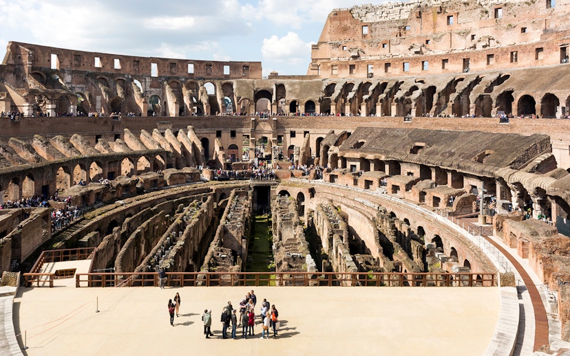 Colosseum arena floor with tourists on a semi-private tour, Rome.