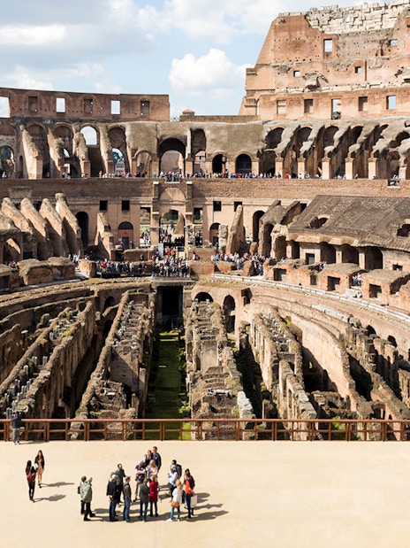 Colosseum arena floor with tourists on a semi-private tour, Rome.