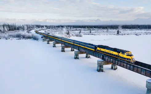 Aurora Winter Train crossing snowy landscape on Alaska Rail Road.