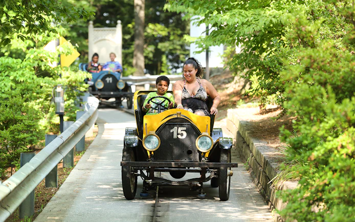 Visitors driving vintage Hanson Cars at Six Flags Over Georgia.