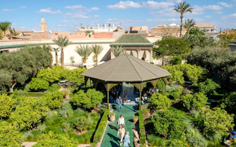 Le Jardin Secret garden with pavilion and visitors, Marrakech.
