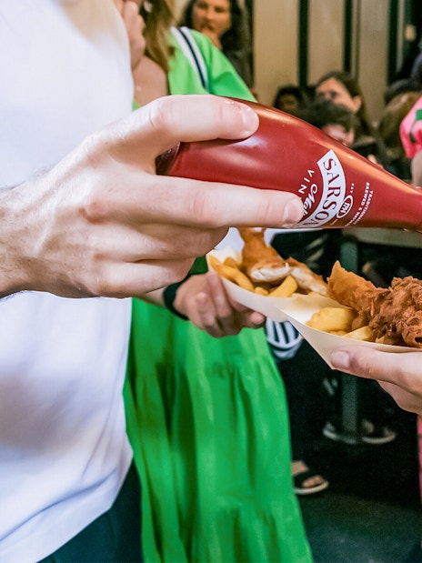 People enjoying fish and chips at Borough Market on the Bankside Food Tour in London.